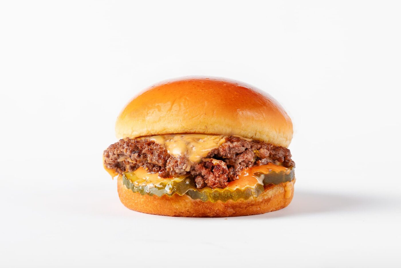 Classic Smash burger with American cheese and dill pickle chips on a toasted bun
